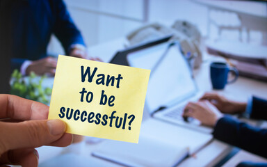 Male hand holding sticky note written Want to be successful?