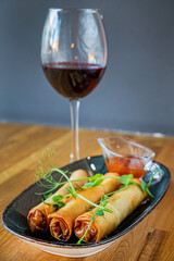 spring rolls with wine in cafe