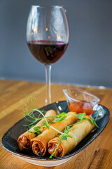 spring rolls with wine in cafe