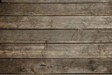 The texture of natural materials. Boardwalk pier on the river bank in the rain and sun	