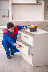 Young male carpenter working at home