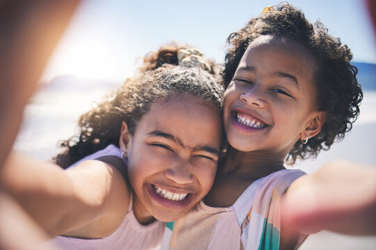 Girl children, hug and selfie at beach with smile on face, sunshine or friends with fun, travel or summer on social media. Female kids, siblings or photography for profile picture, vacation or family