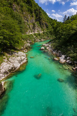 Turquoise colored soça river near Kozjak waterfall in Slovenia