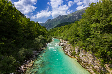 Turquoise colored soça river near Kozjak waterfall in Slovenia