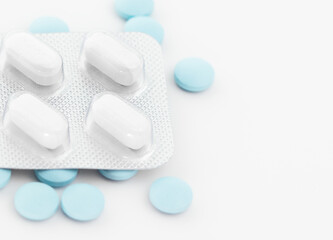 Obraz na płótnie Canvas Blister pack with white tablets and blue pills.
