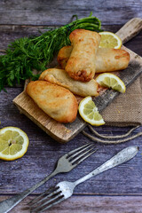   Allasca Pollock Fish  Bites in a crispy Tempura  Batter.Fish and chips .Close up of   crispy breaded  deep fried fish fingers with breadcrumbs s erved with remoulade sauce and  lemon