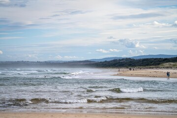 family enjoy a beach holiday in summer, swimming in the sea