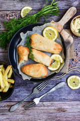  Allasca Pollock Fish  Bites in a crispy Tempura  Batter.Fish and chips .Close up of   crispy breaded  deep fried fish fingers with breadcrumbs s erved with remoulade sauce and  lemon