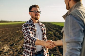 Two partners came to an agreement and they shake hands.