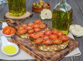 toast bread with cherry tomato and olive oil with rosemary