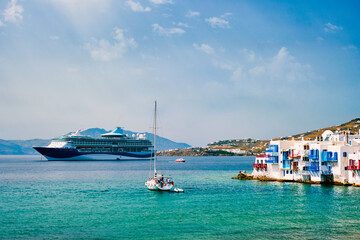Little Venice houses in Chora Mykonos town with yacht and cruise ship. Mykonos island, Greecer