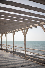 Fototapeta na wymiar Wooden pier, gazebo with access to the sea.