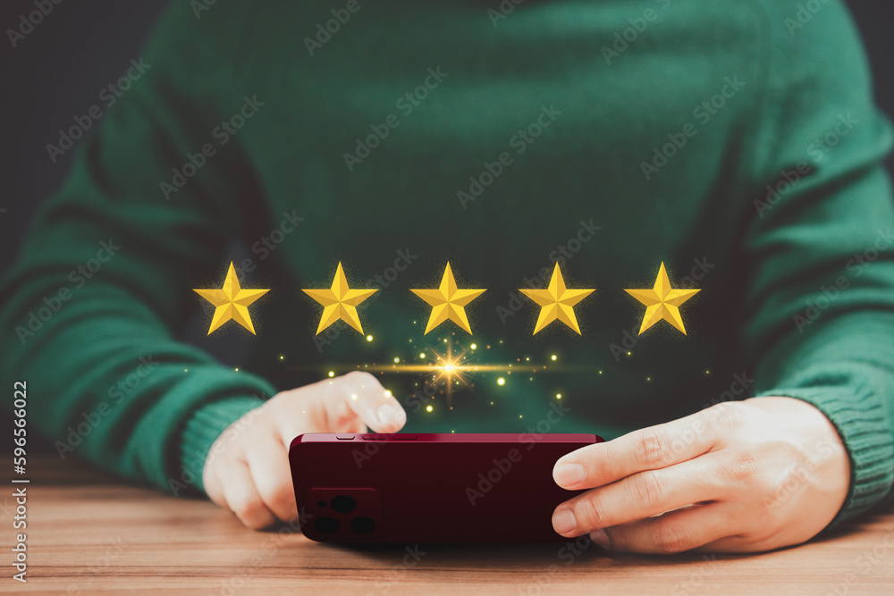 Poster man's hand using a smartphone and give five star symbol to increase rating of product and service co