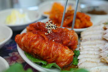 Korean traditional food with thinly sliced boiled pork and freshly made cabbage kimchi