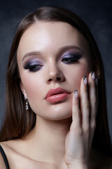 Portrait of female face. Hand with black french manicure nailsnear face