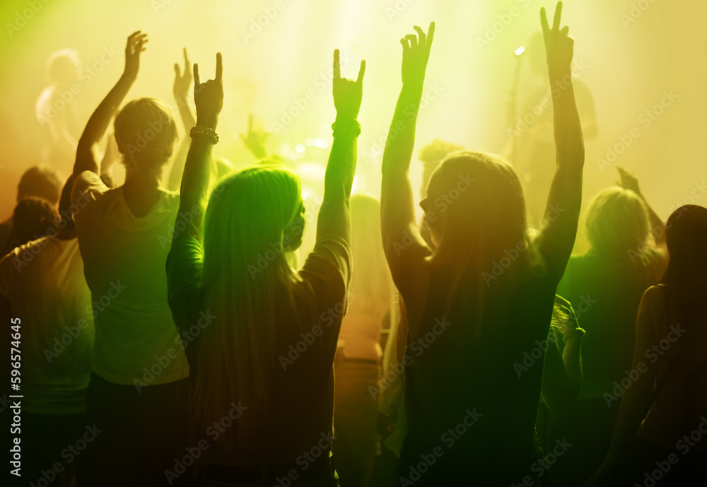 Wall mural rock music, friends and women dancing at concert or festival from back, yellow neon light and energy