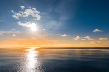 Fototapeta premium Beautiful colorful sunset sky with reflection of the sun in the Indian Ocean.