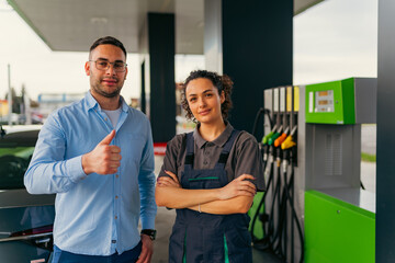 The man is satisfied with the service at the gas station