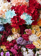 background with colorful artificial flowers
