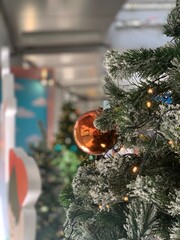 Fototapeta na wymiar Decorative christmas tree features light wire, snowflake, and ornaments 
