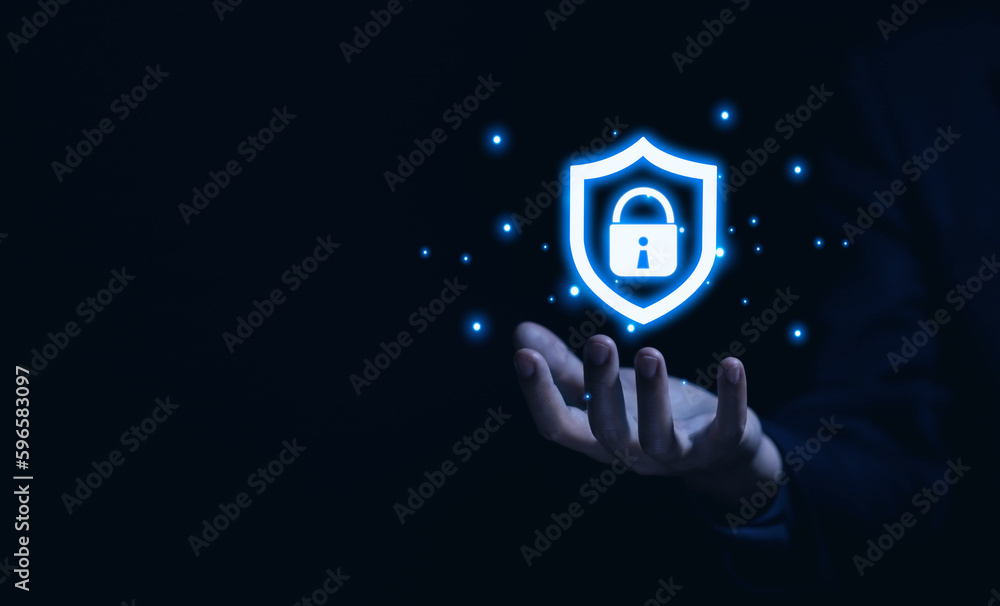 Aufkleber hand shows a shield icon with a lock sign. computer data password protection concept.