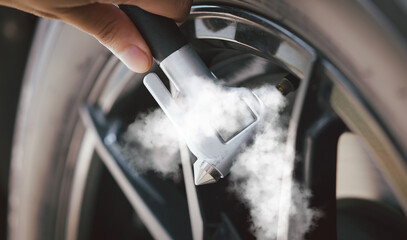 inspection Measure quantity Inflated Rubber tires car Close up hand holding machine Inflated pressure gauge for car tyre pressure measurement for automotive automobile  © NOTE OMG