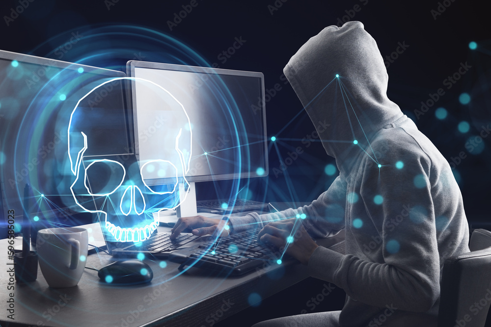 Poster hacker at desk using laptop with digital blue skull hologram on dark background. ransomeware, virus 