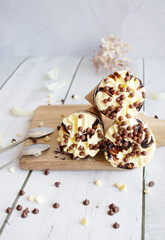 
Vanilla chocolate ice cream cone. On a white wooden background. Sweets