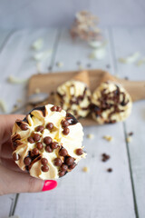 
Vanilla chocolate ice cream cone. On a white wooden background. Sweets