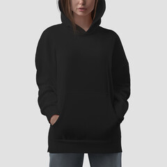 Mockup of a black hoodie with slits on the sides on a girl in a hood with hands in pockets, front...