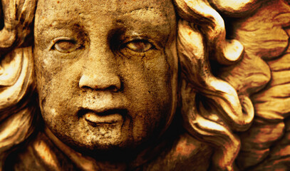 Macro image of angel of death. Fragment of an ancient statue.