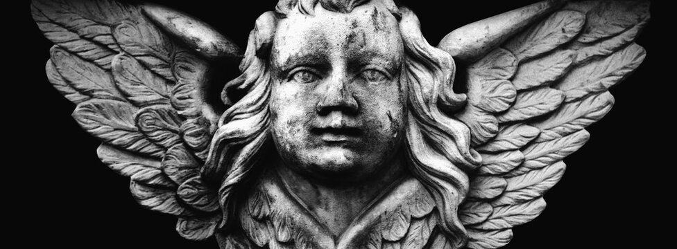 Antique stone statue of angel. Retro filter and vintage style. Black and white image.