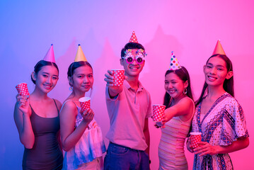 Five party goers being carefree and having a great time. 5 young people on a plain background lit...