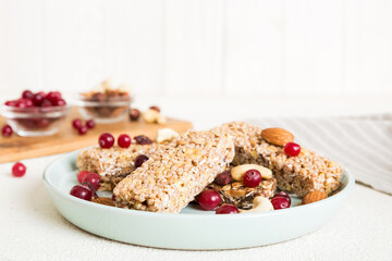 Various granola bars on table background. Cereal granola bars. Superfood breakfast bars with oats, nuts and berries, close up. Superfood concept