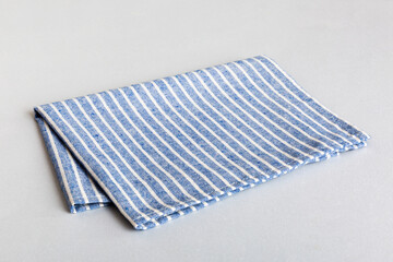top view with blue kitchen napkin isolated on table background. Folded cloth for mockup with copy...