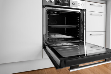 Open electric oven in modern kitchen
