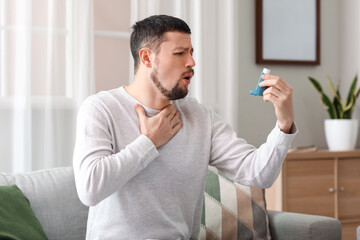 Sick man with inhaler at home