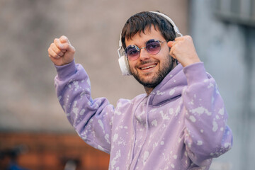 young man with headphones and expression of success