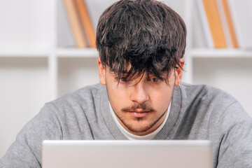 student looking at computer or laptop