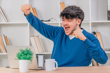 student at desk with computer or laptop