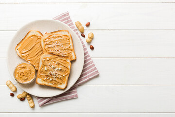Peanut butter sandwiches or toasts on light table background.Breakfast. Vegetarian food. American...