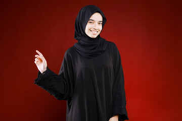 Beautiful business woman with hijab portrait on color background