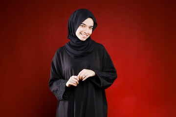 Beautiful business woman with hijab portrait on color background