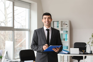 Young accountant with document in office