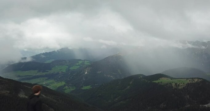Drone shot passing by a running adventurer on top of a mountain to reveal Germany's beautiful countryside.