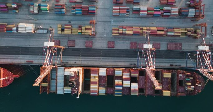 Straight down close-up aerial.Containers and Container ships at the dock in a harbour. Global supply chain.Logistics.Distribution