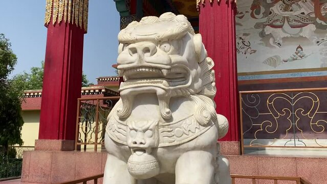 Stone Lion statue in front gate of Tibetan Karma Kagyu Temple (Tibet Monastery) near Mahabodhi Temple in Bodh Gaya.