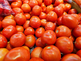Fresh tomatoes on a basket. Ripe tomatoes sell on a Thailand local market. Tomatoes in supermarket