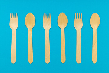 cutlery set made of wood on a blue background