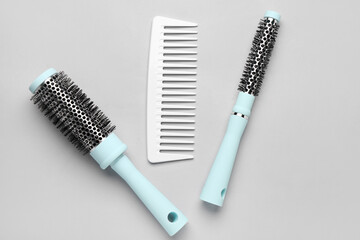 Hairdresser's brushes on grey background